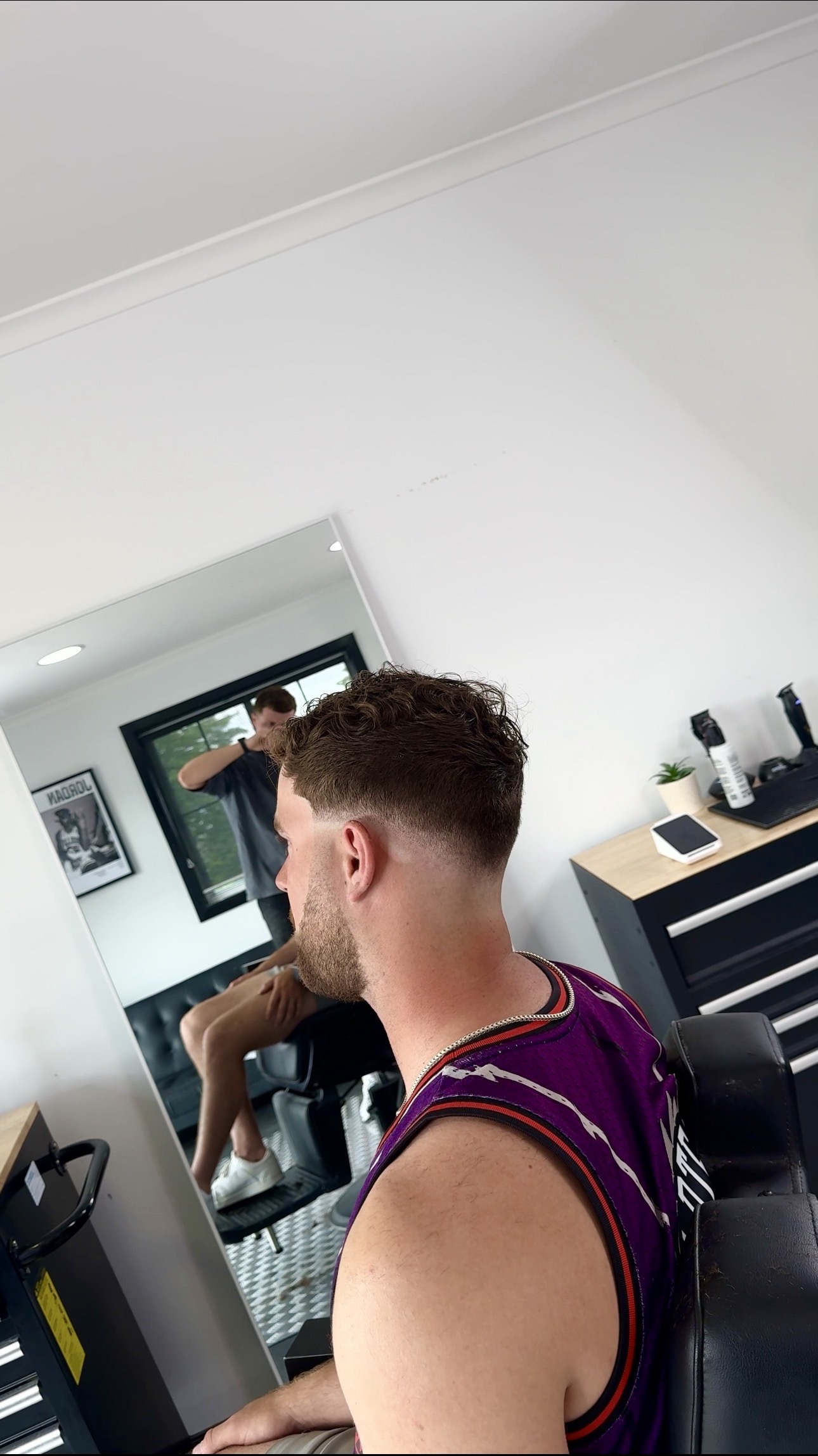 Textured curly top with a skin fade