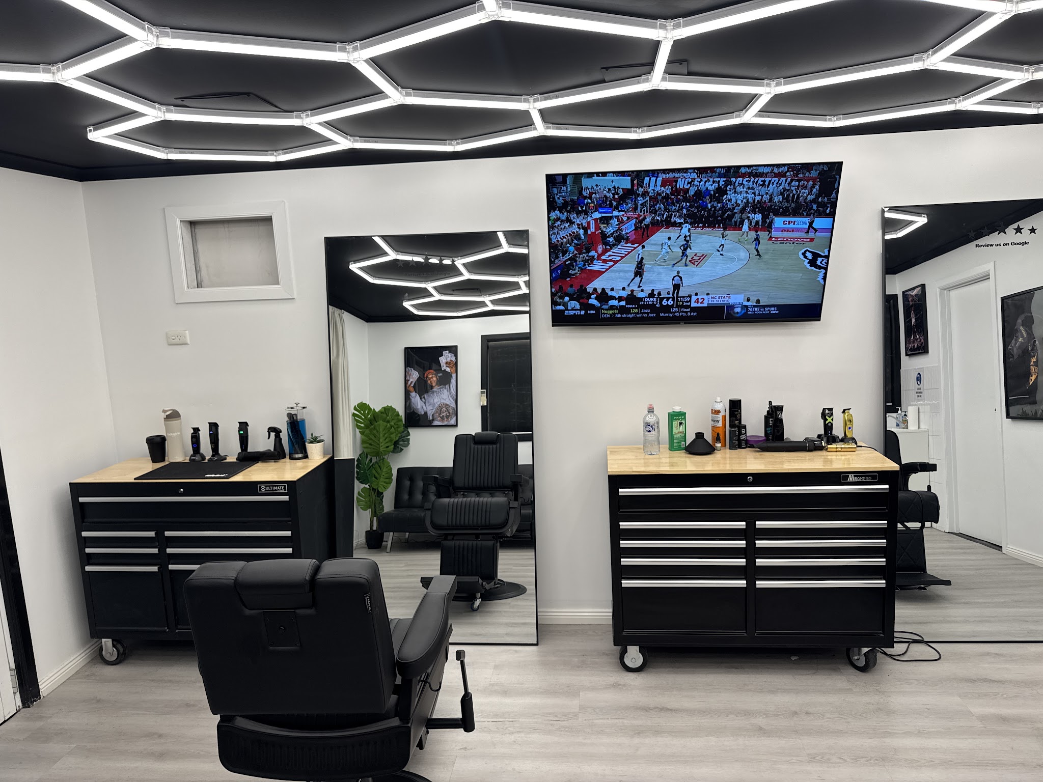 Inside Vision Barber Studio, hexagon light grid over two barber chairs