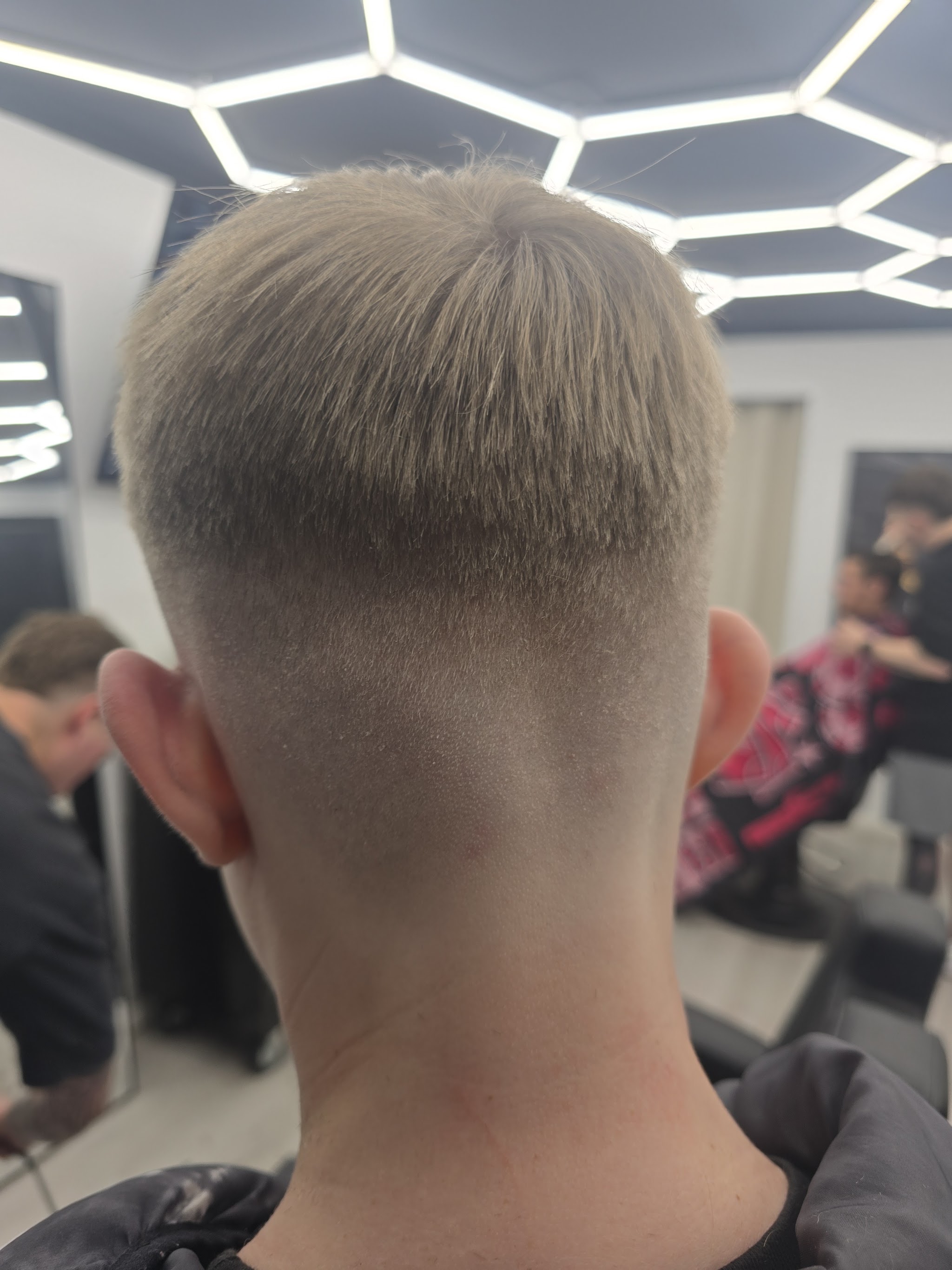 A finished skin fade, photographed by a customer in the studio